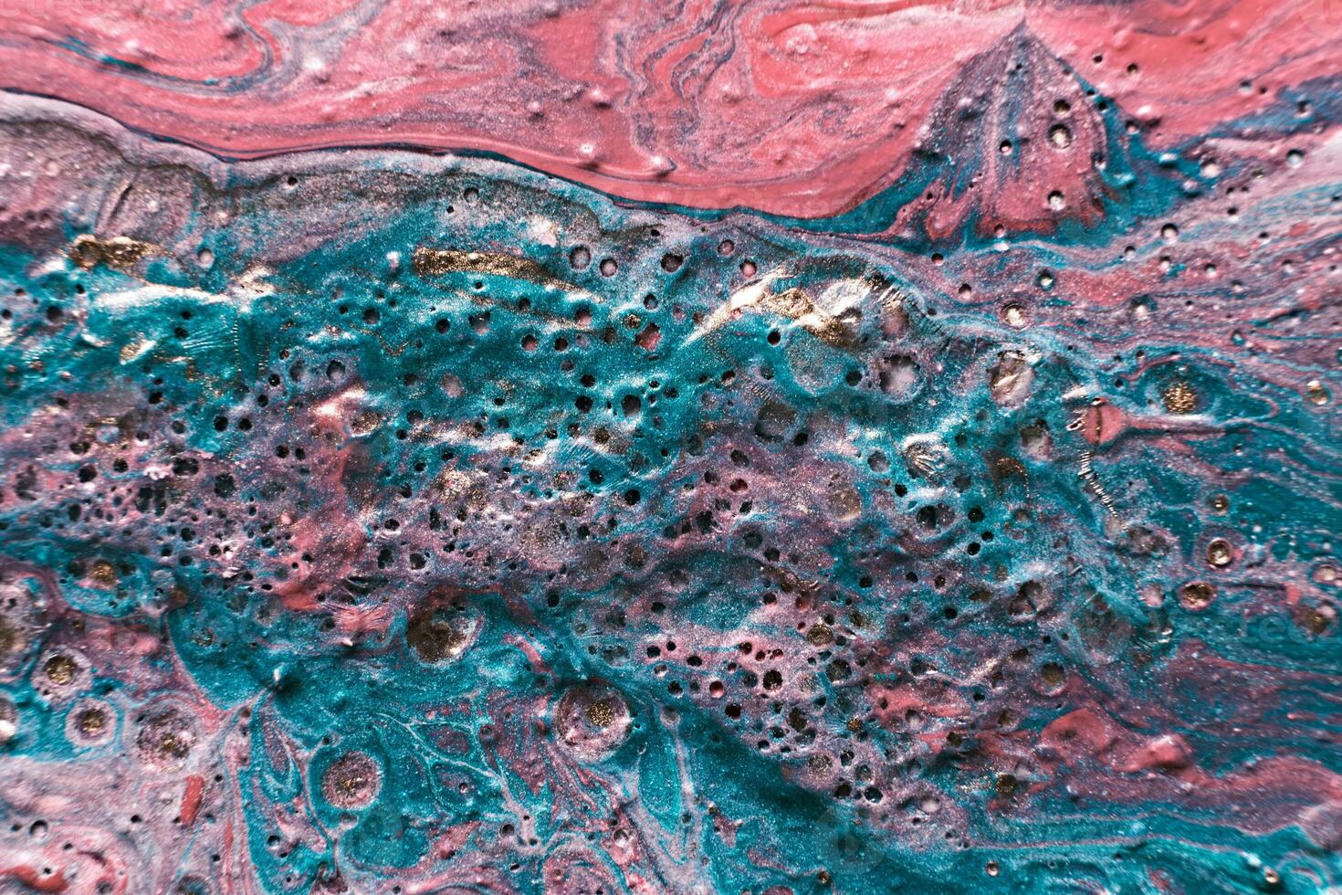 Fluid Art. Embossed mixing, craters and drips of pink and turquoise paint. Marble effect background or texture photo