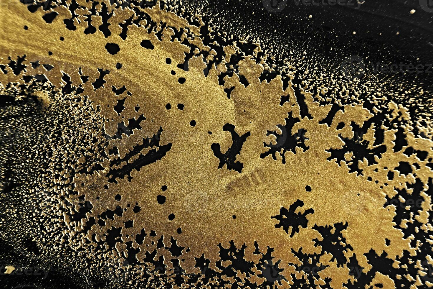 Fluid Art. Metallic gold abstract waves on Black background. Marble effect background or texture photo