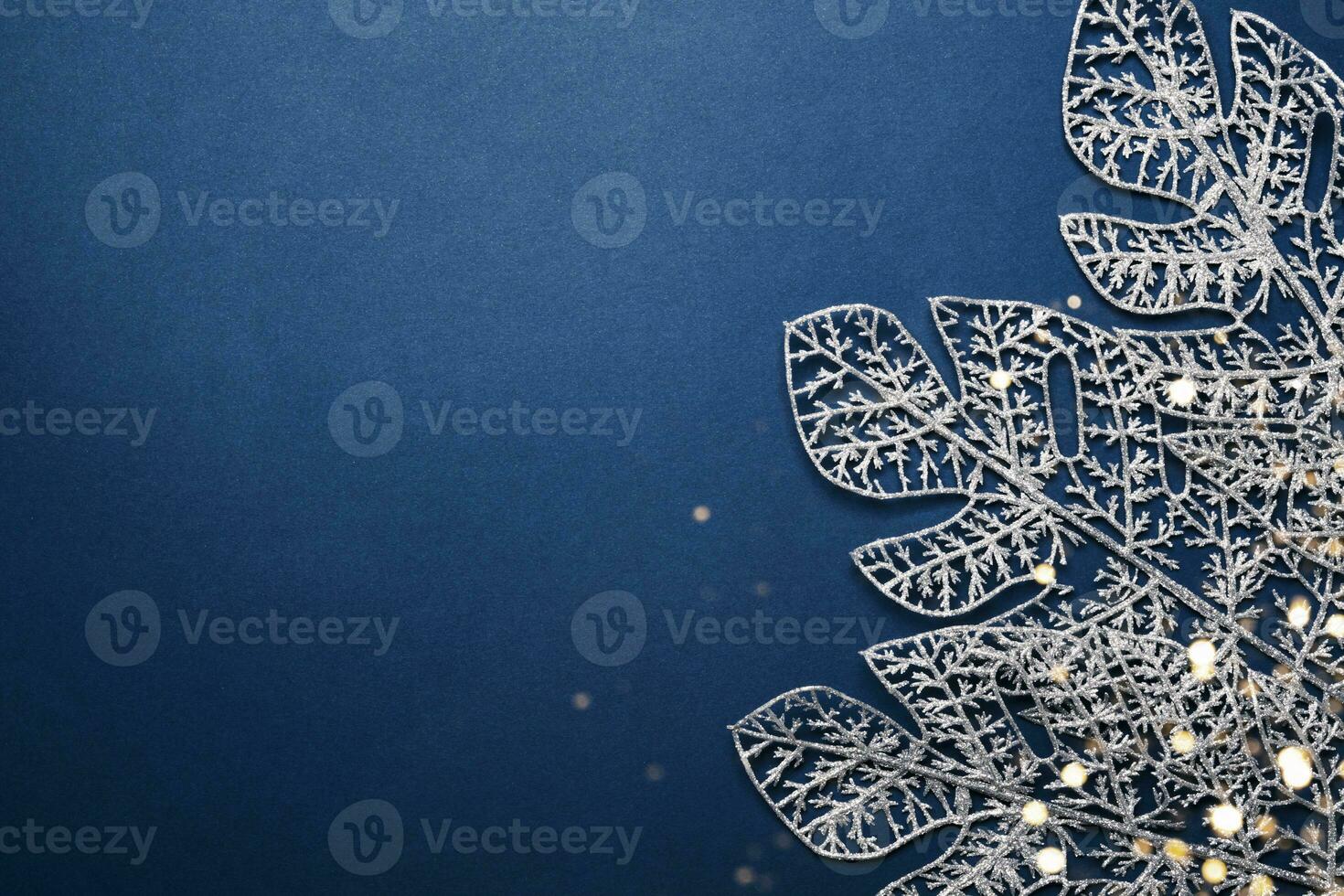 Christmas blue background. Shining silver pattern made of frost decorative leaves photo