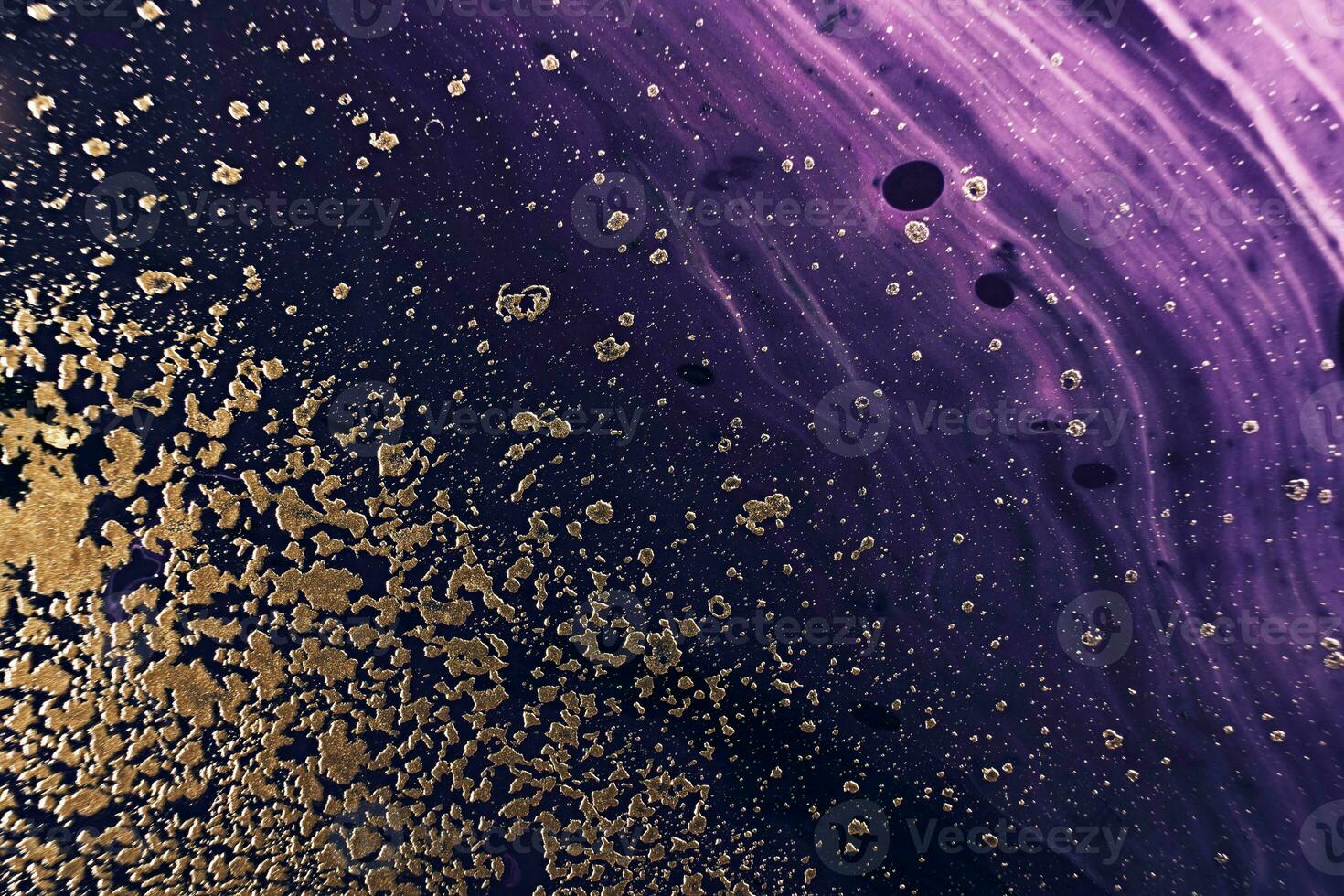 Fluid Art. Metallic gold particles and black purple waves. Marble effect background or texture photo