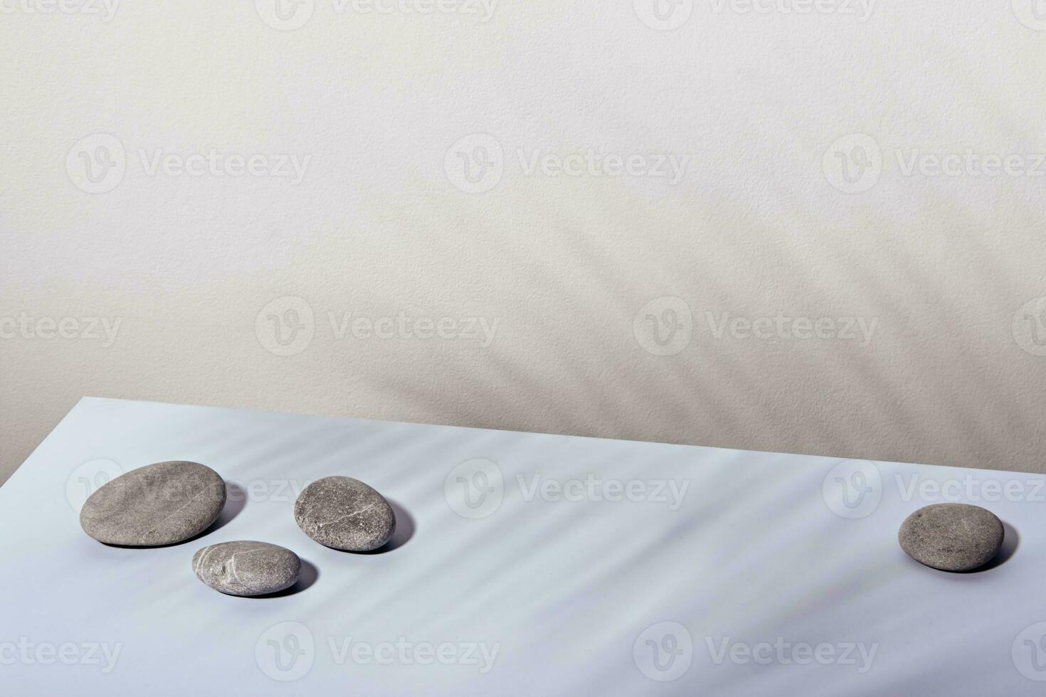 Minimal modern product display. Round stones and palm leaf shadow. Nature aesthetic and Eco trends photo