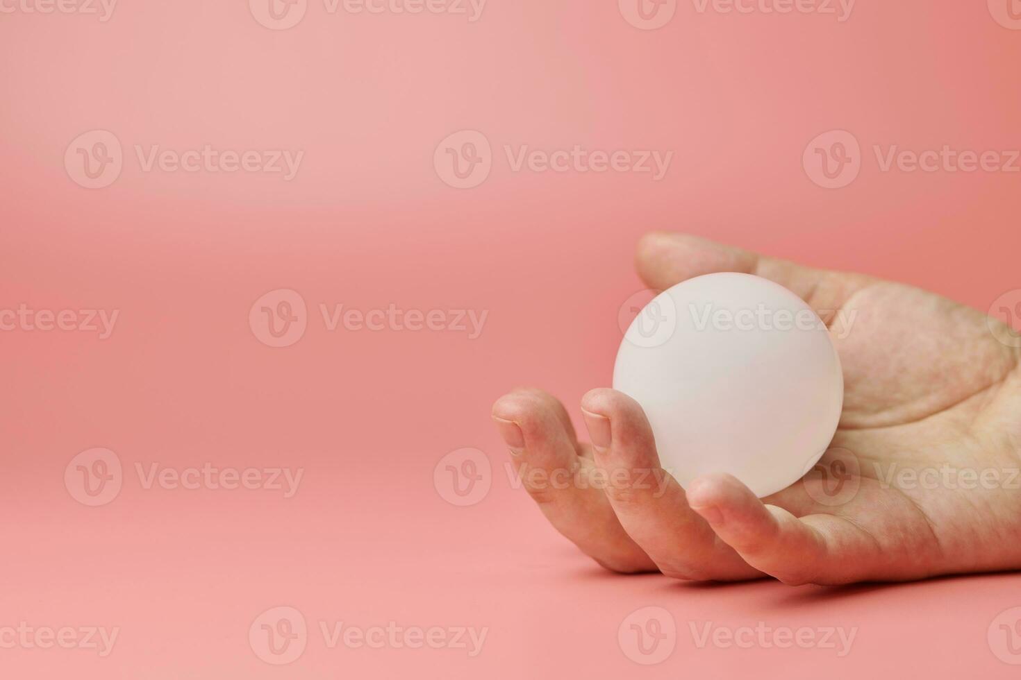 Crystal ball in hand, copy space. Magic solution or new idea concept. Creative minimal innovations. photo