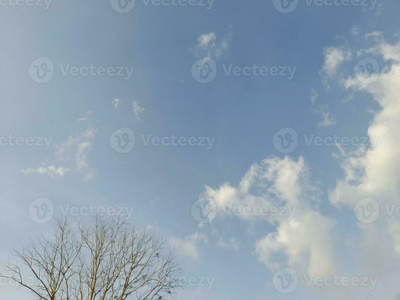 Beautiful white clouds on deep blue sky background. Large bright soft fluffy clouds are cover the entire blue sky. Skyscape on Lombok Island, Indonesia photo