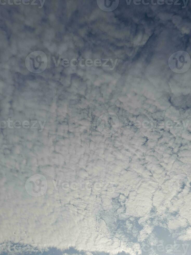 Beautiful white clouds on deep blue sky background. Large bright soft fluffy clouds are cover the entire blue sky. Skyscape on Lombok Island, Indonesia photo