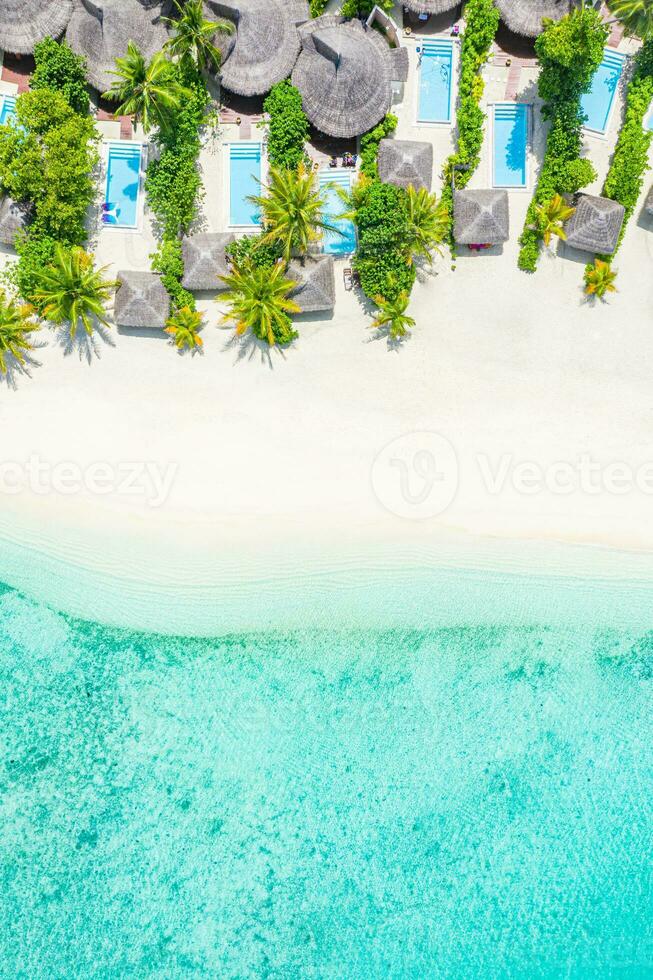 Sea beach aerial. Luxury summer travel vacation landscape. Tropical beach, drone view. Beach villas bungalows of hotel resort. Perfect beach scene vacation, summer holiday template. Wonderful nature photo