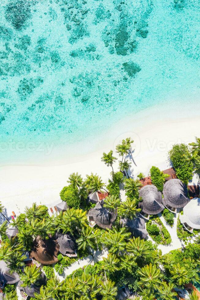 Sea beach aerial. Luxury summer travel vacation landscape. Tropical beach, drone view. Beach villas bungalows of hotel resort. Perfect beach scene vacation, summer holiday template. Wonderful nature photo