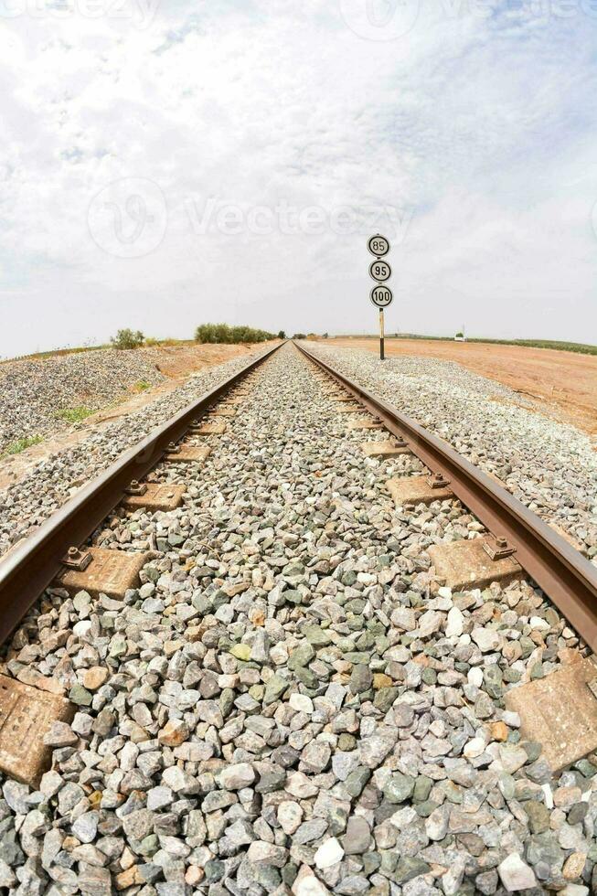 a railroad track with a stop sign in the middle photo