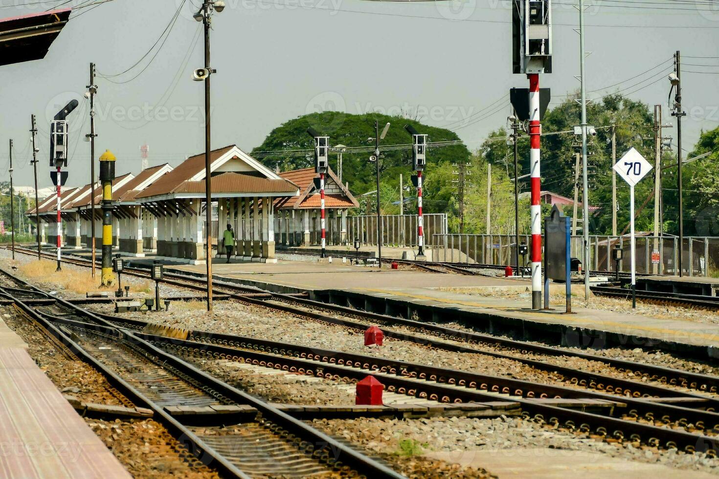 a train station with a platform and tracks photo