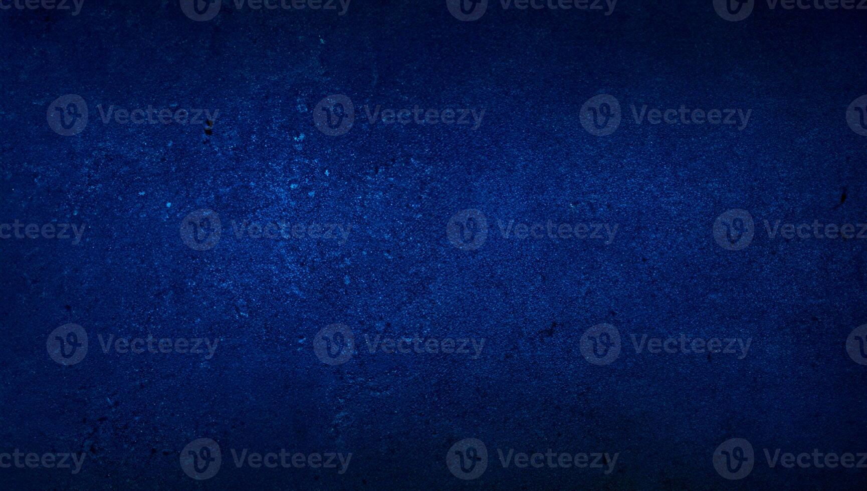blank blue texture surface background with dark corners. blue grainy cement wall background with space for text. photo