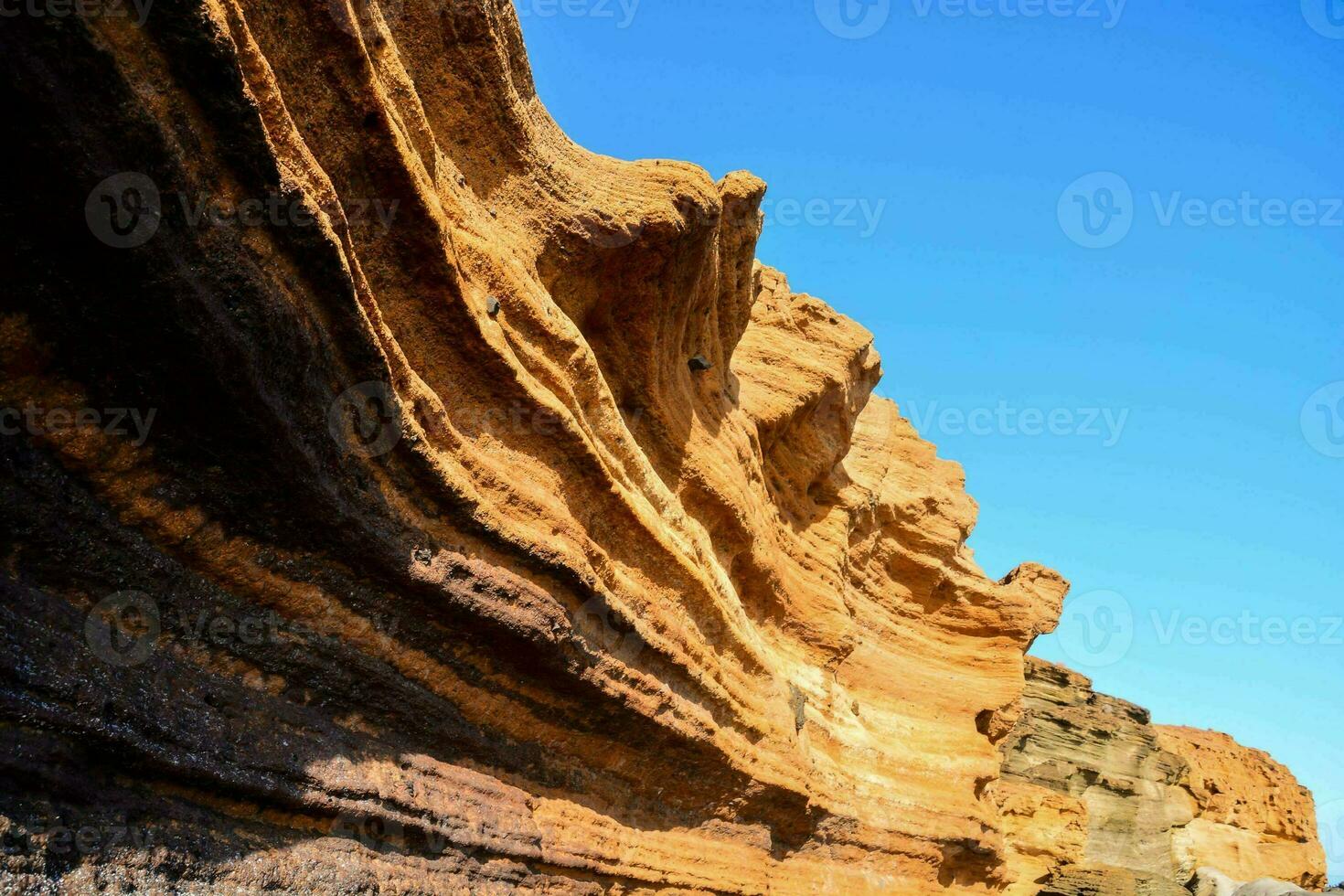 the rock formations on the beach are very tall photo