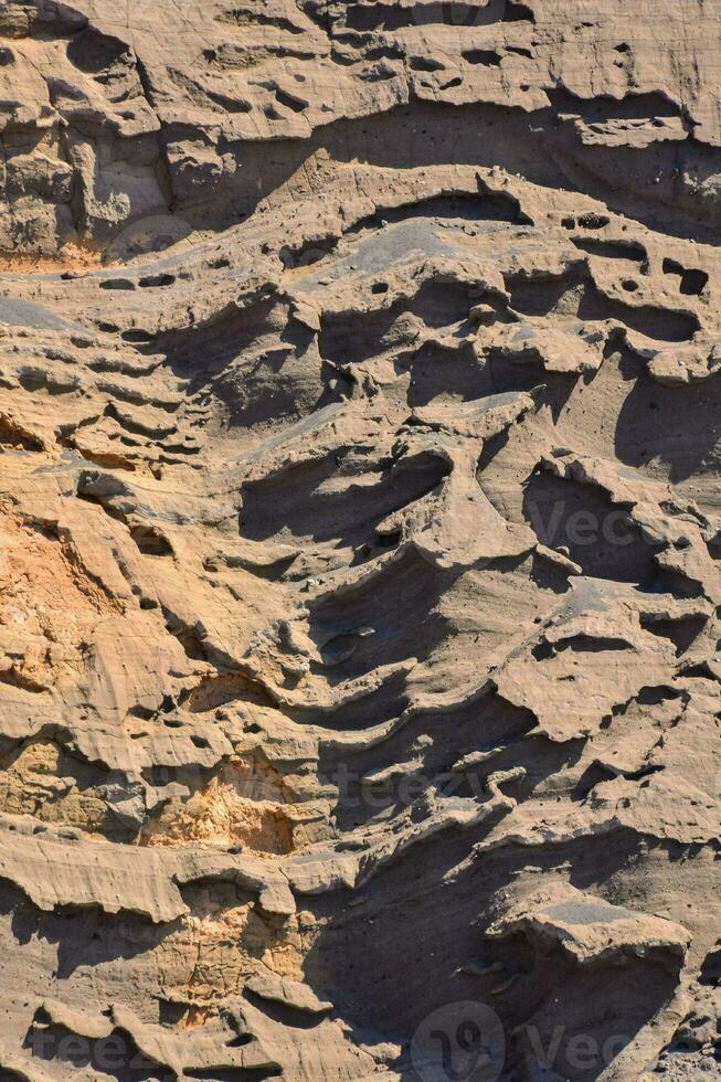 a rock formation with many different patterns photo