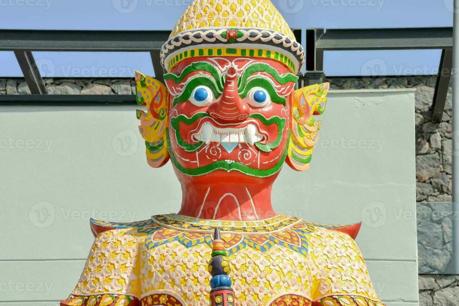 a colorful statue of a man with a smile on his face photo