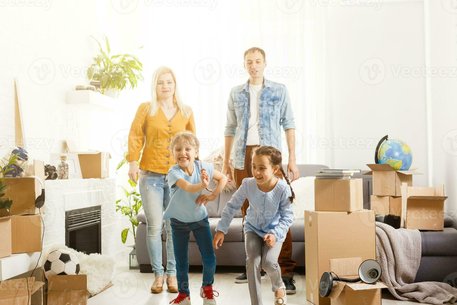 Happy family with cardboard boxes in new house at moving day. photo