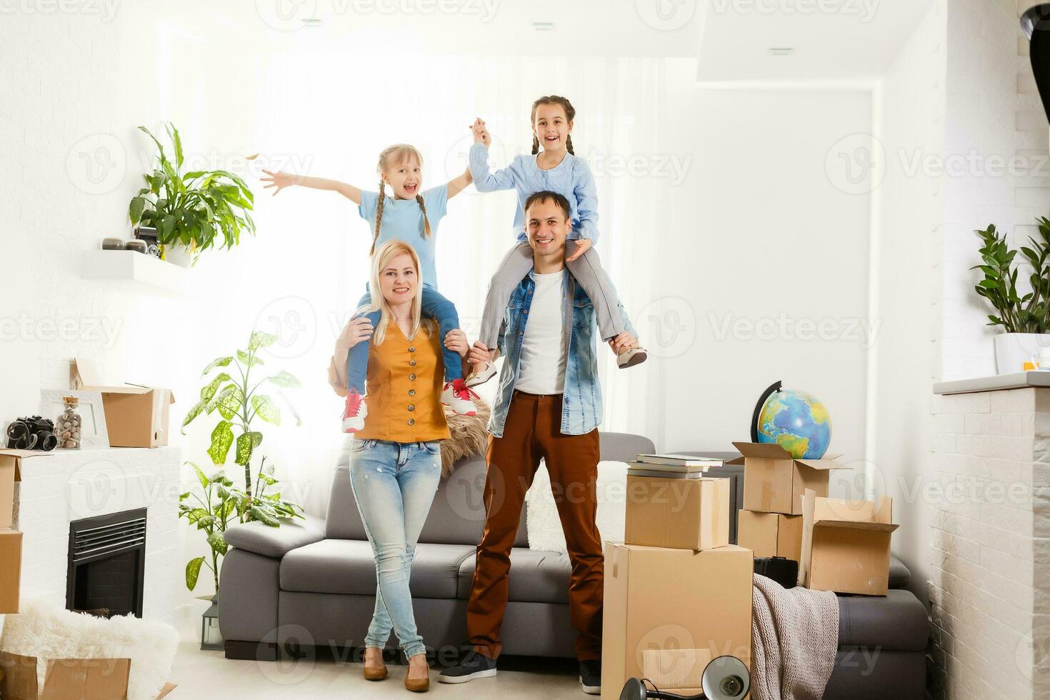 Happy family with cardboard boxes in new house at moving day. photo