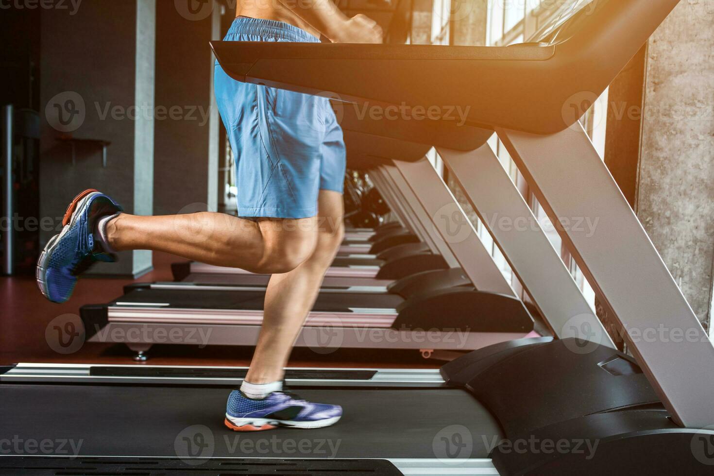 Legs running on the treadmill close up photo