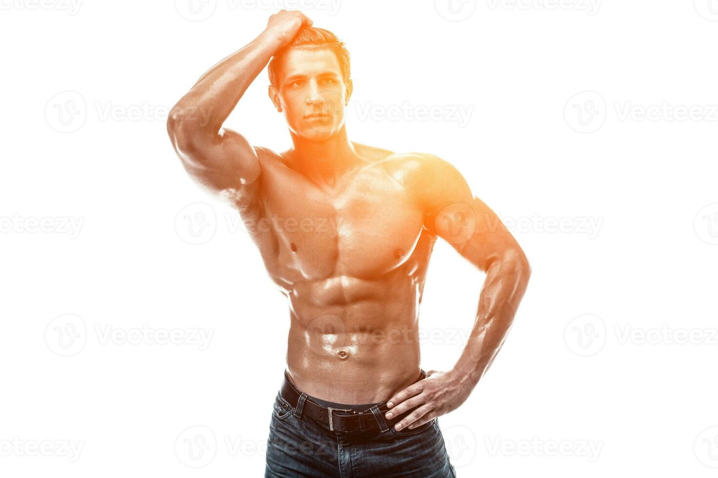 Muscular handsome young man with naked torso. Isolated on white photo