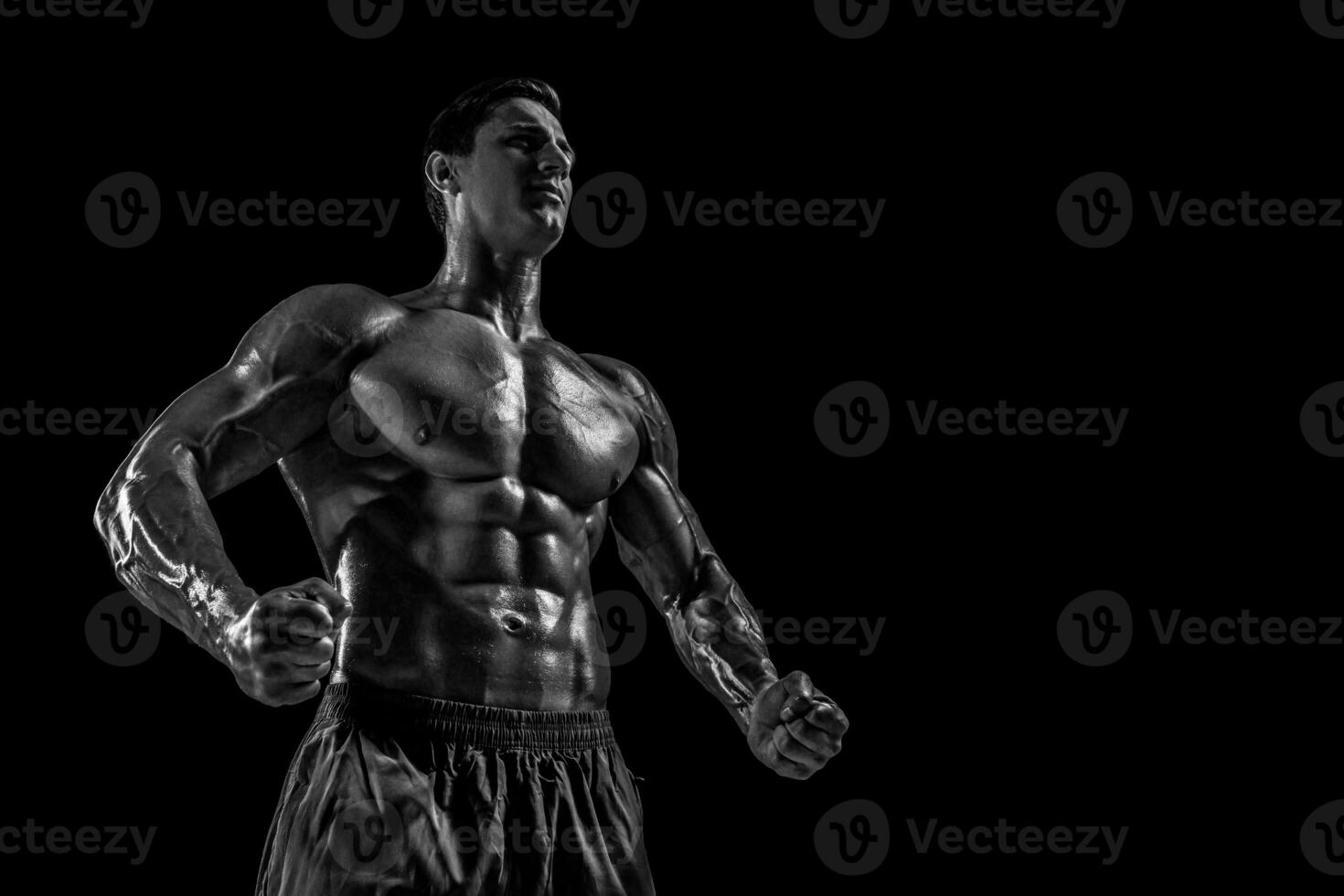 Muscular and fit young bodybuilder fitness male model posing ove photo