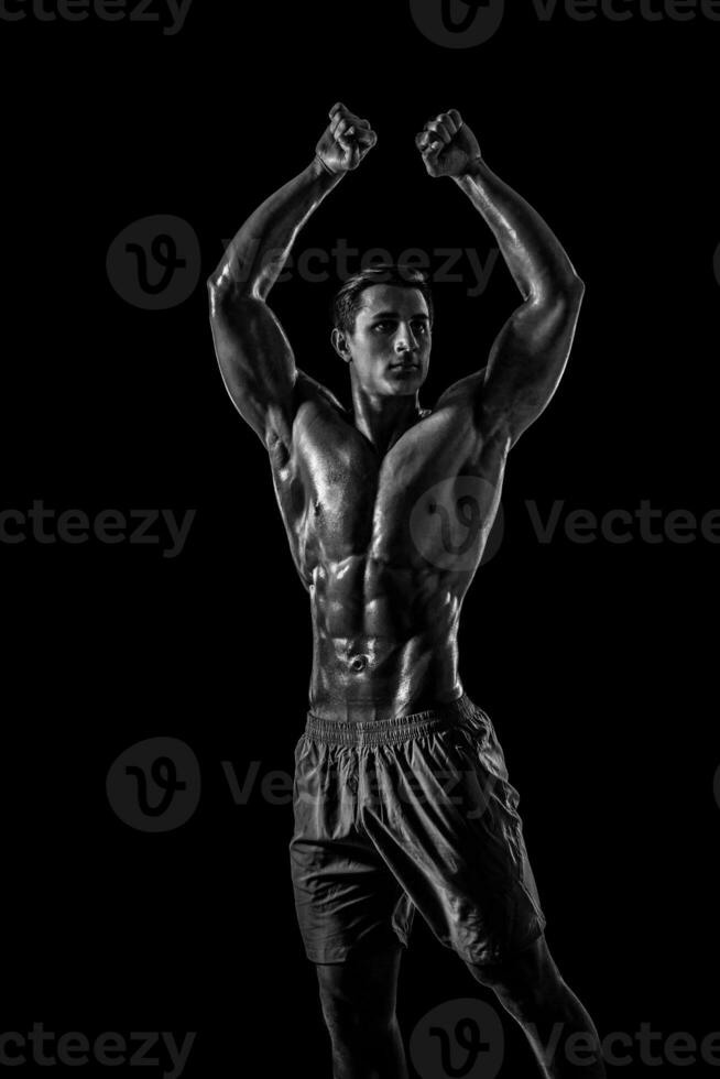 Muscular and fit young bodybuilder fitness male model posing ove photo