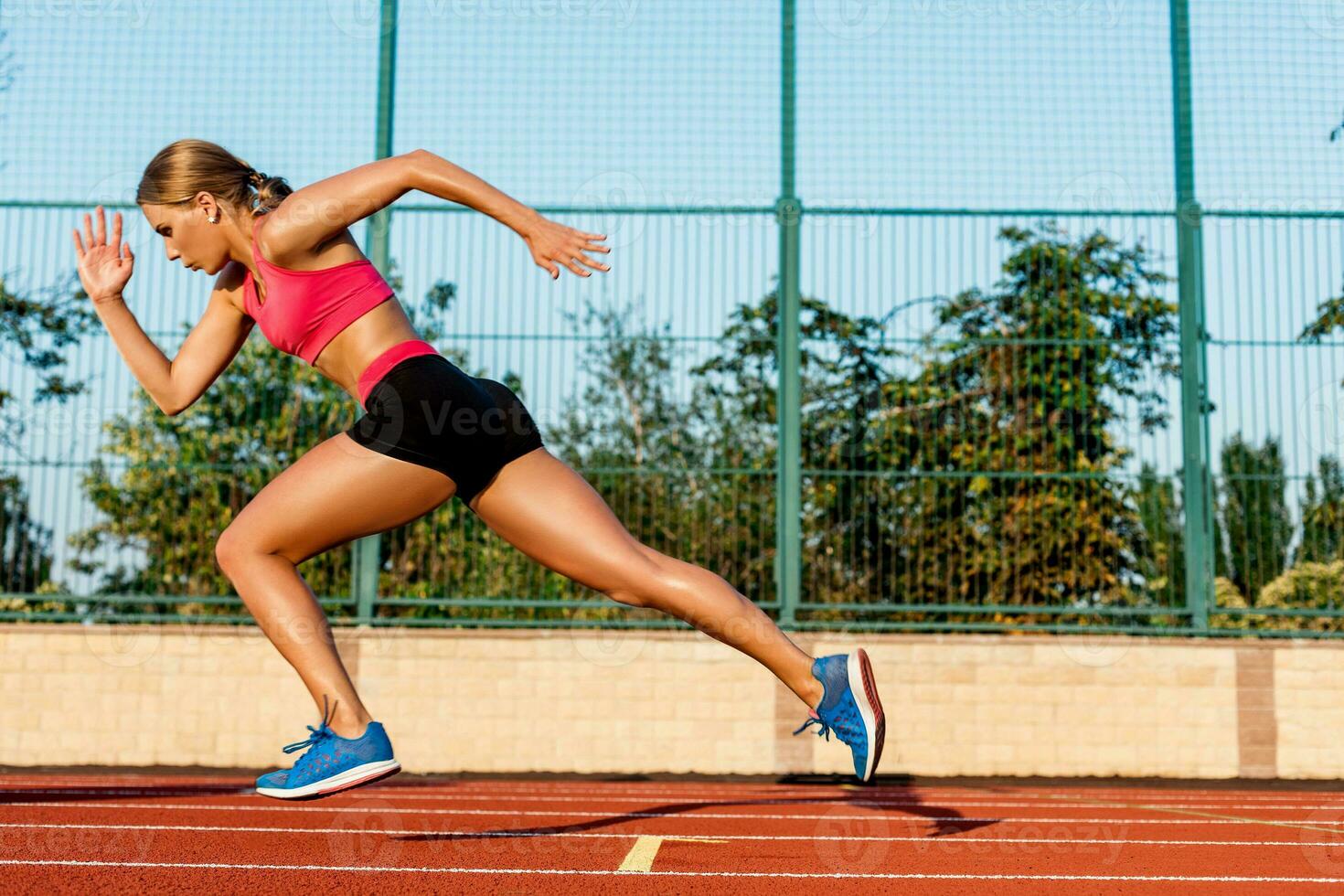 Runner sprinting towards success on run path running athletic track. Goal achievement concept. photo