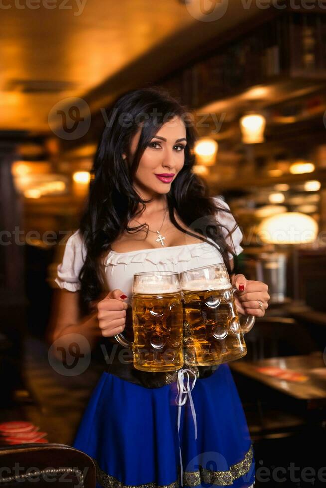 Young waitress brings beer to visitors photo