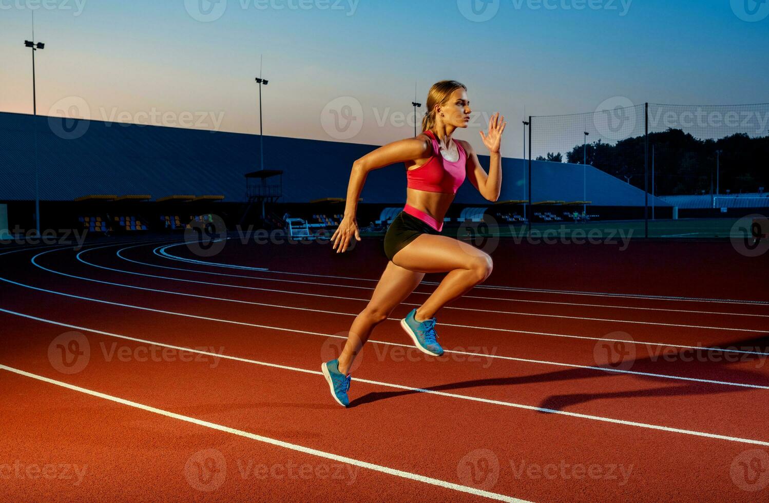 Runner sprinting towards success on run path running athletic track. Goal achievement concept. photo