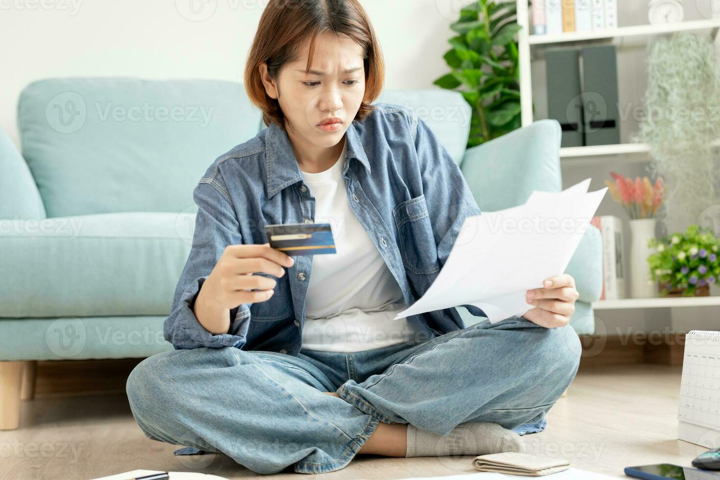 Stressed and headache asian woman with large bills or invoices no money to pay to expenses and credit card debt. shortage, Financial problems, mortgage, loan, bankruptcy, bankrupt, poor, empty wallet photo