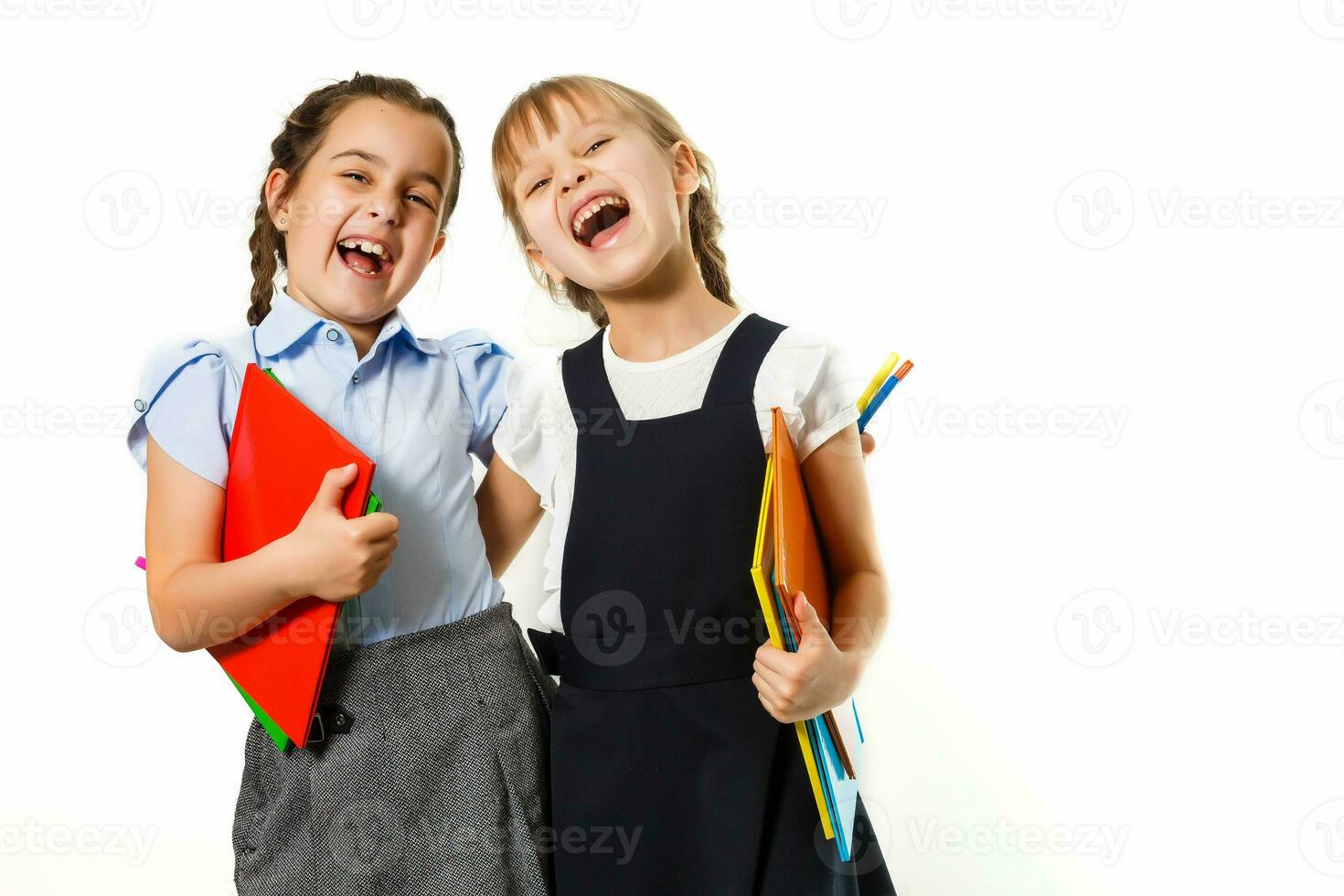Two little schoolgirls. Education, fashion, friendship concept. photo