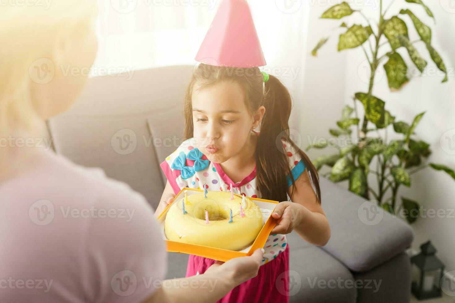 Happy girl sibling celebrating birthday via internet in quarantine time, self-isolation and family values, online birthday party. Congratulations animator via laptop, online. Stay at home photo