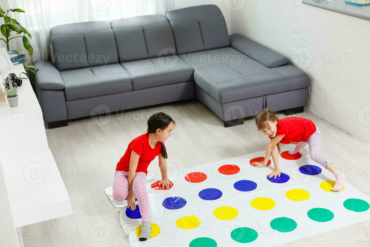 two little girls Having Fun Playing Game On Floor At Home. Siblings Friendship photo
