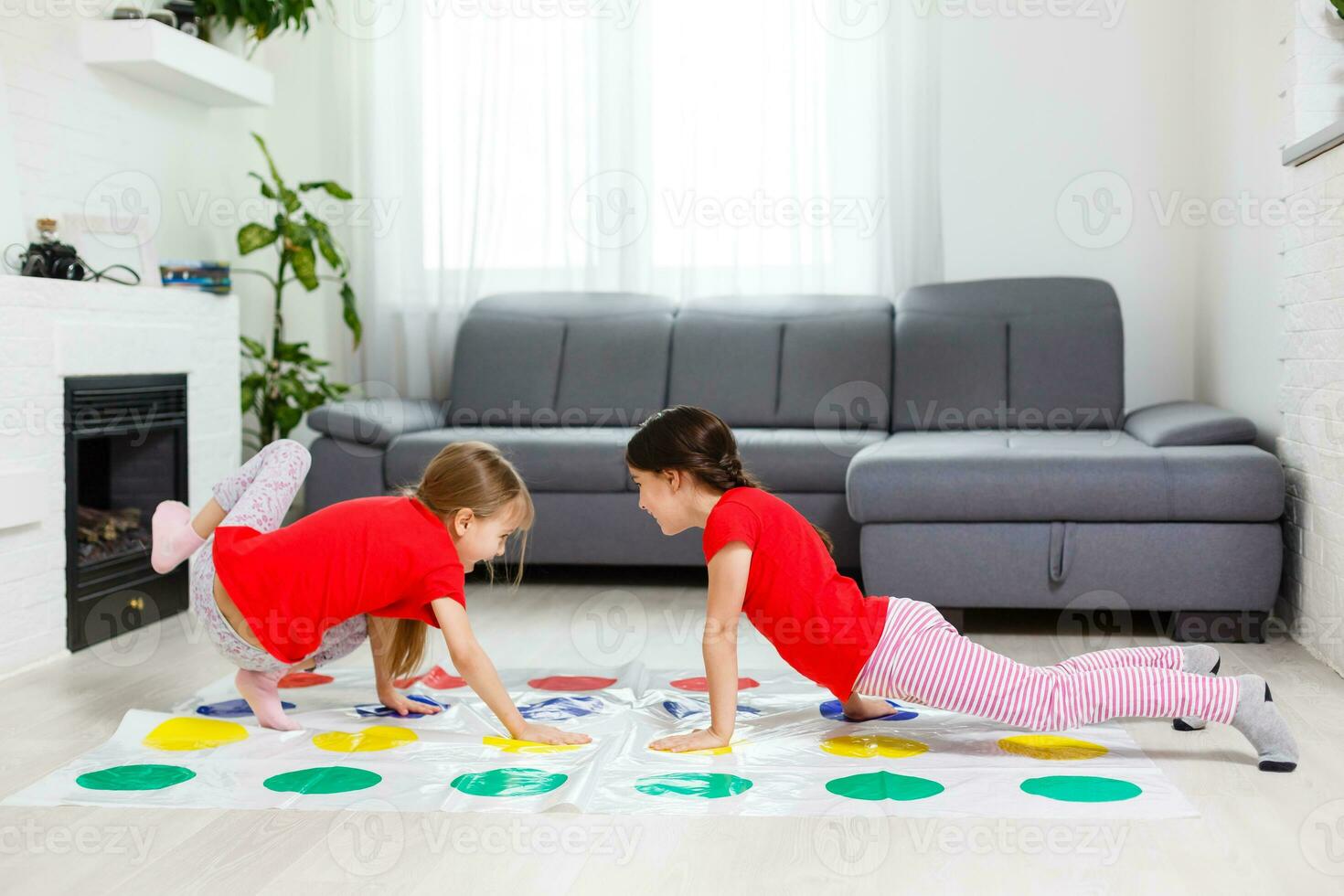 two little girls Having Fun Playing Game On Floor At Home. Siblings Friendship photo