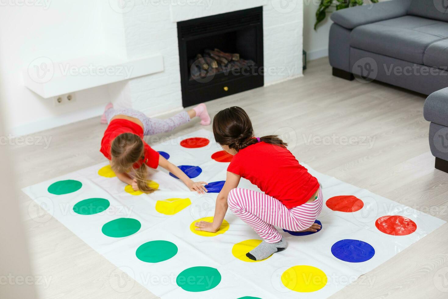 two little girls Having Fun Playing Game On Floor At Home. Siblings Friendship photo