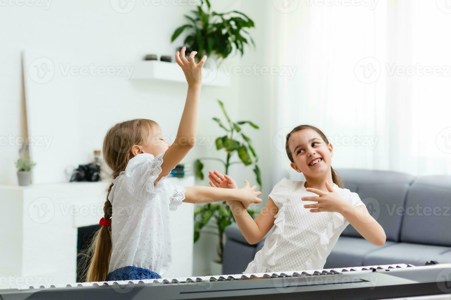 Home lesson on music for the girl on the piano. The idea of activities for the child at home during quarantine. Music concept photo