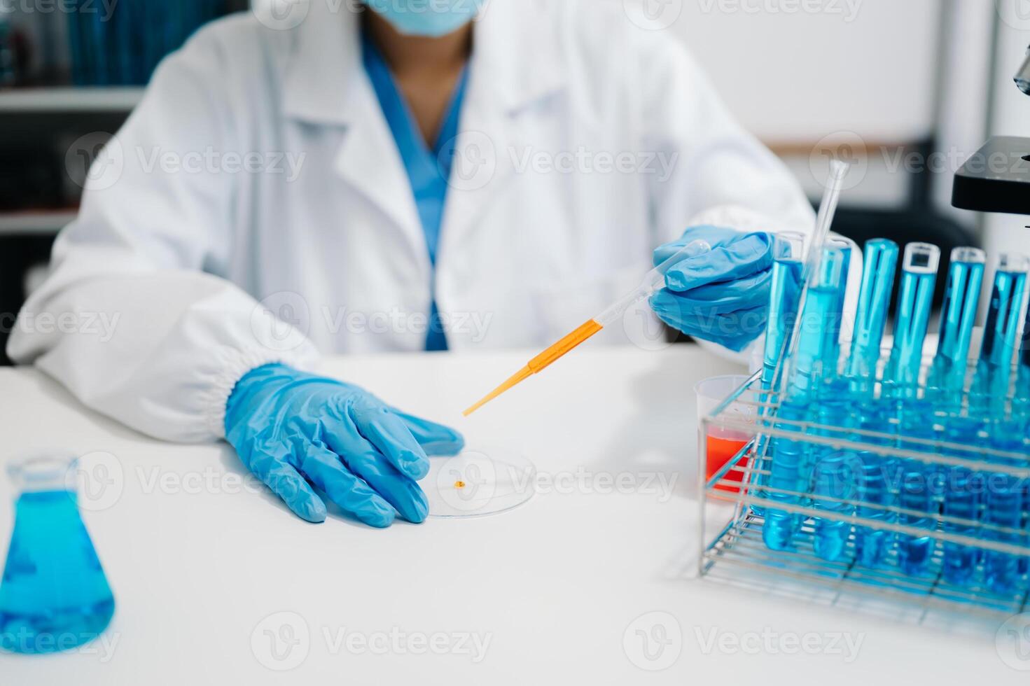 female scientist working with micro pipettes analyzing biochemical ...