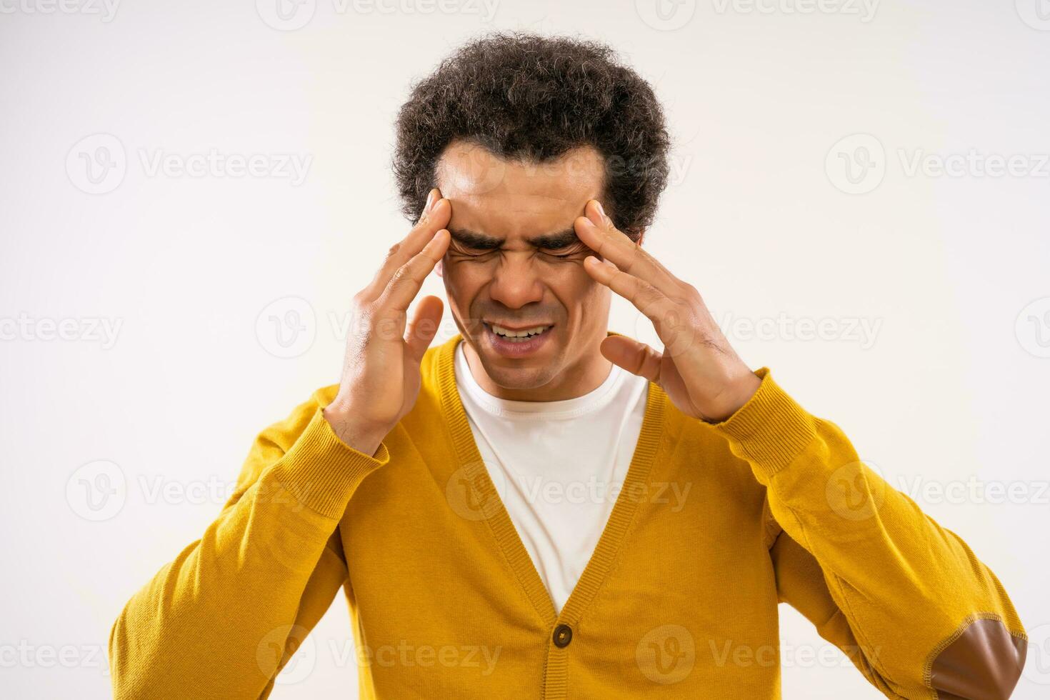 Studio shot portrait of multiracial man who is having headache. photo