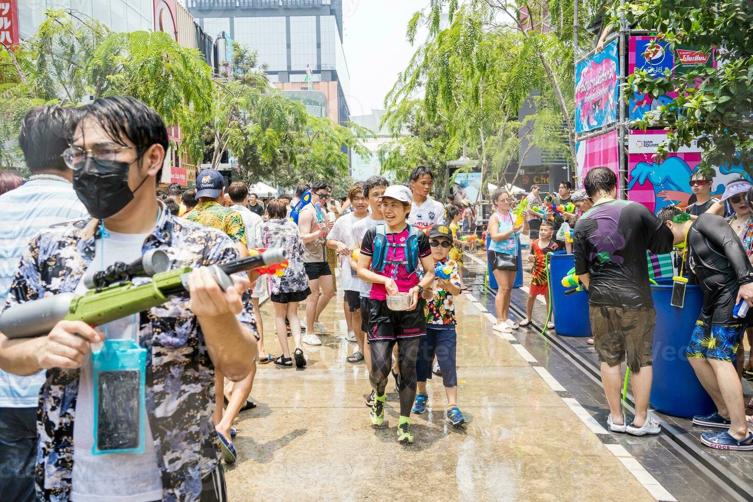 Siam Square, Bangkok, Thailand - APR 13, 2023 Songkran Festival, The short action of people joins celebrations of the Thai New Year or Songkran in Siam Square Bangkok, Thailand. photo