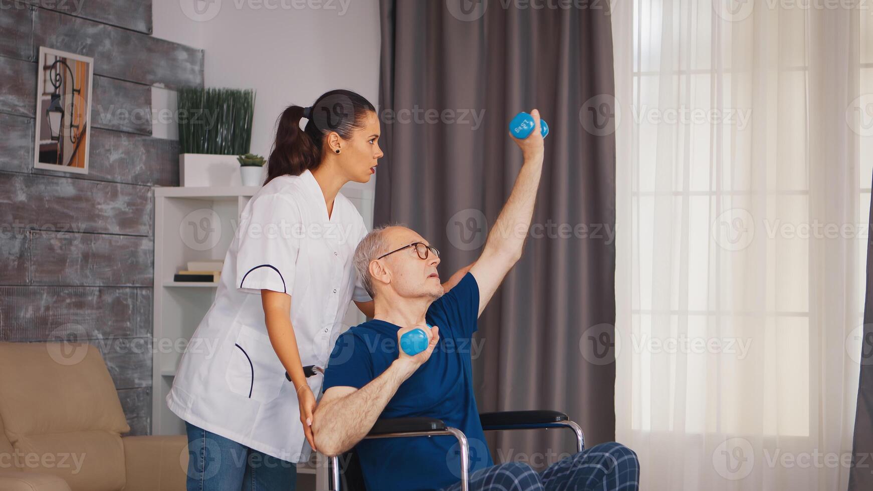 Senior man in wheelchair doing professional injury recovery. Disabled handicapped old person with social worker in recovery support therapy physiotherapy healthcare system nursing retirement home photo