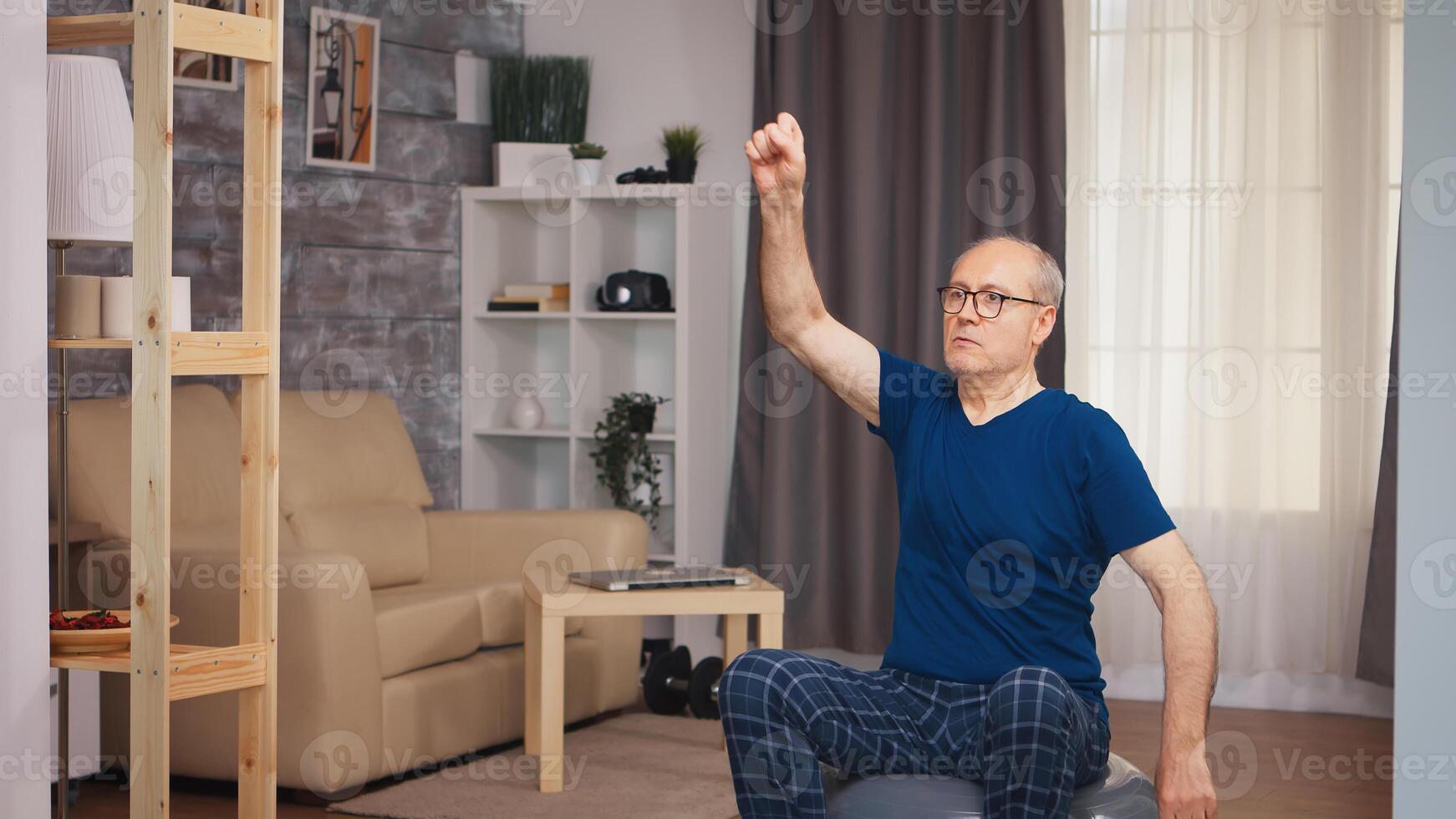Senior man doing warm up exercise before fitness training. Old person pensioner healthy training healthcare sport at home, exercising fitness activity at elderly age photo
