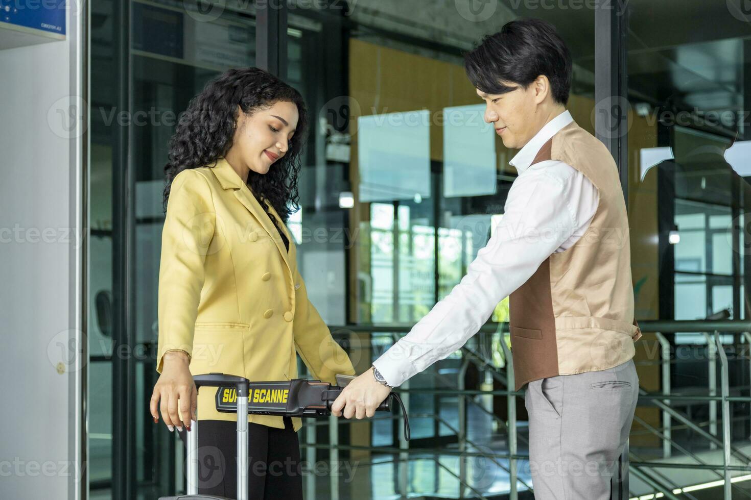 Airline ground staff is using metal scanner for security check every passenger in the airport departure terminal for safety protocol before boarding into the plane photo