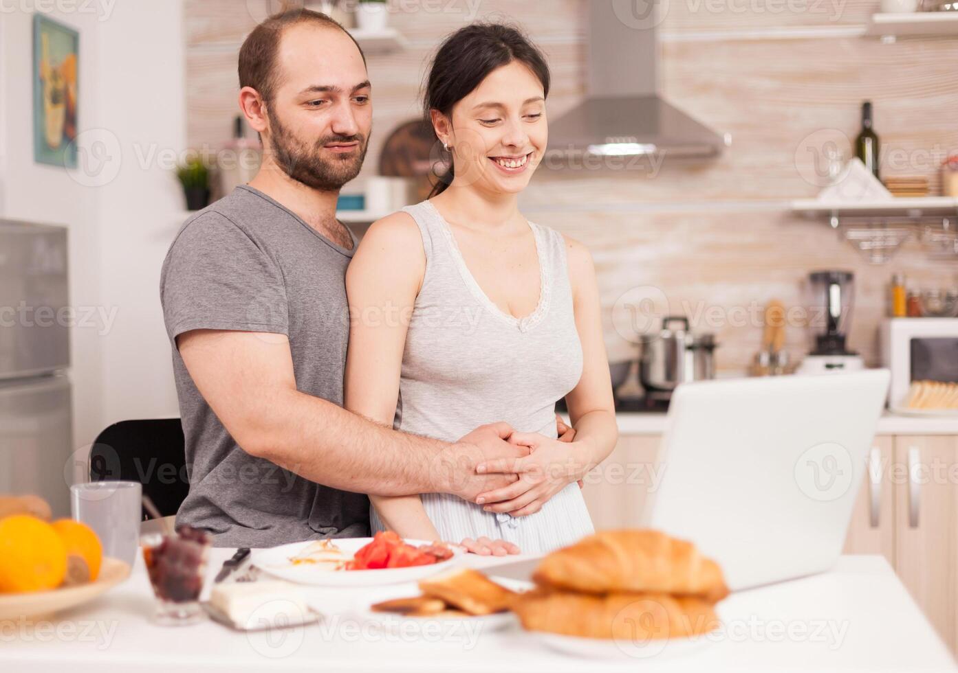 Couple doing online shopping on laptop during breakfast. Entering information, customer using ecommerce technology buying stuff on the web, cosumerism banking and ordering photo