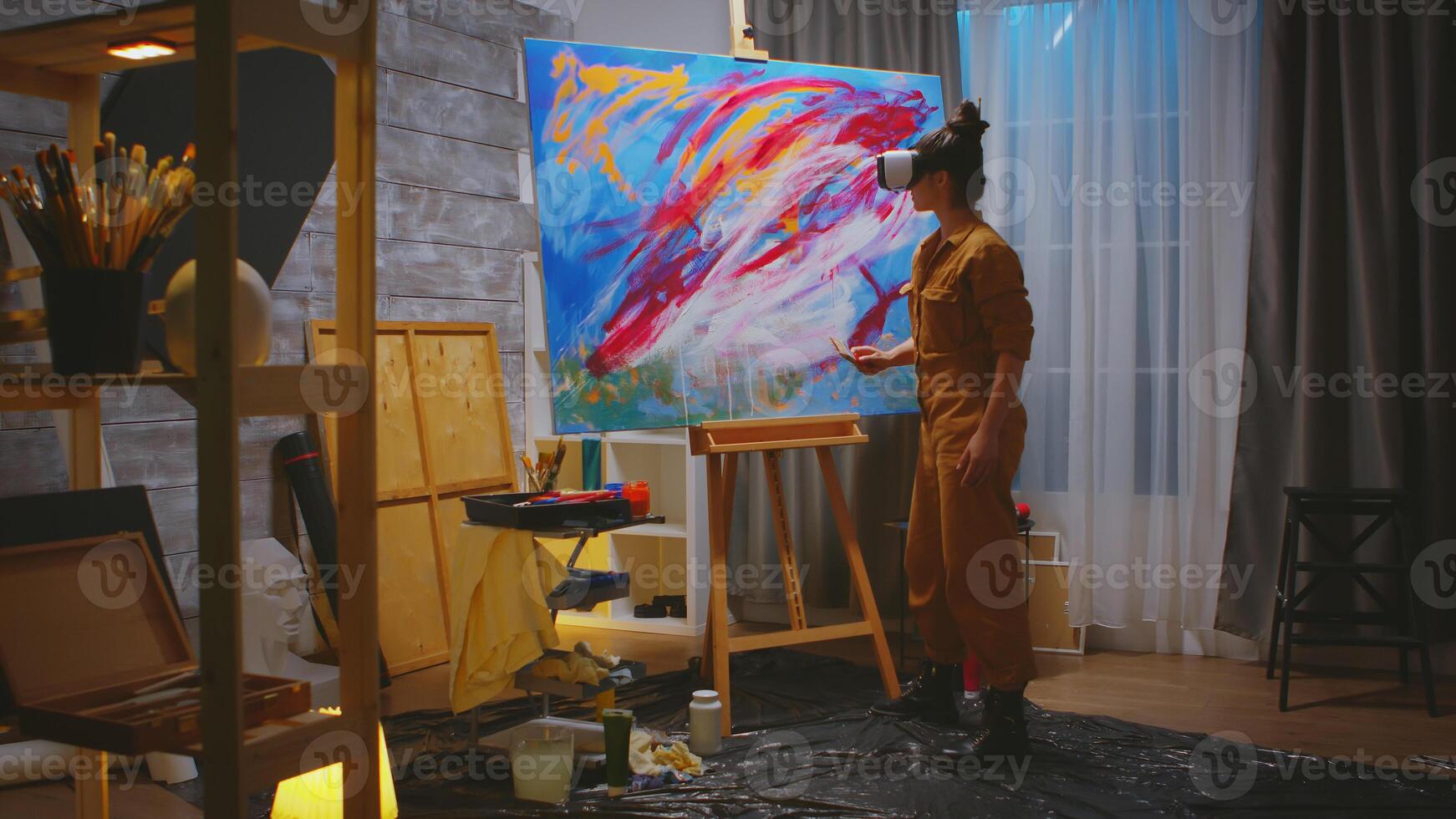 Female painter working on abstract painting in studio. photo