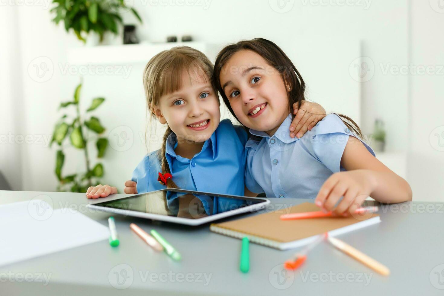 Pretty stylish schoolgirls studying during her online lesson at home, social distance during quarantine, self-isolation, online education concept photo