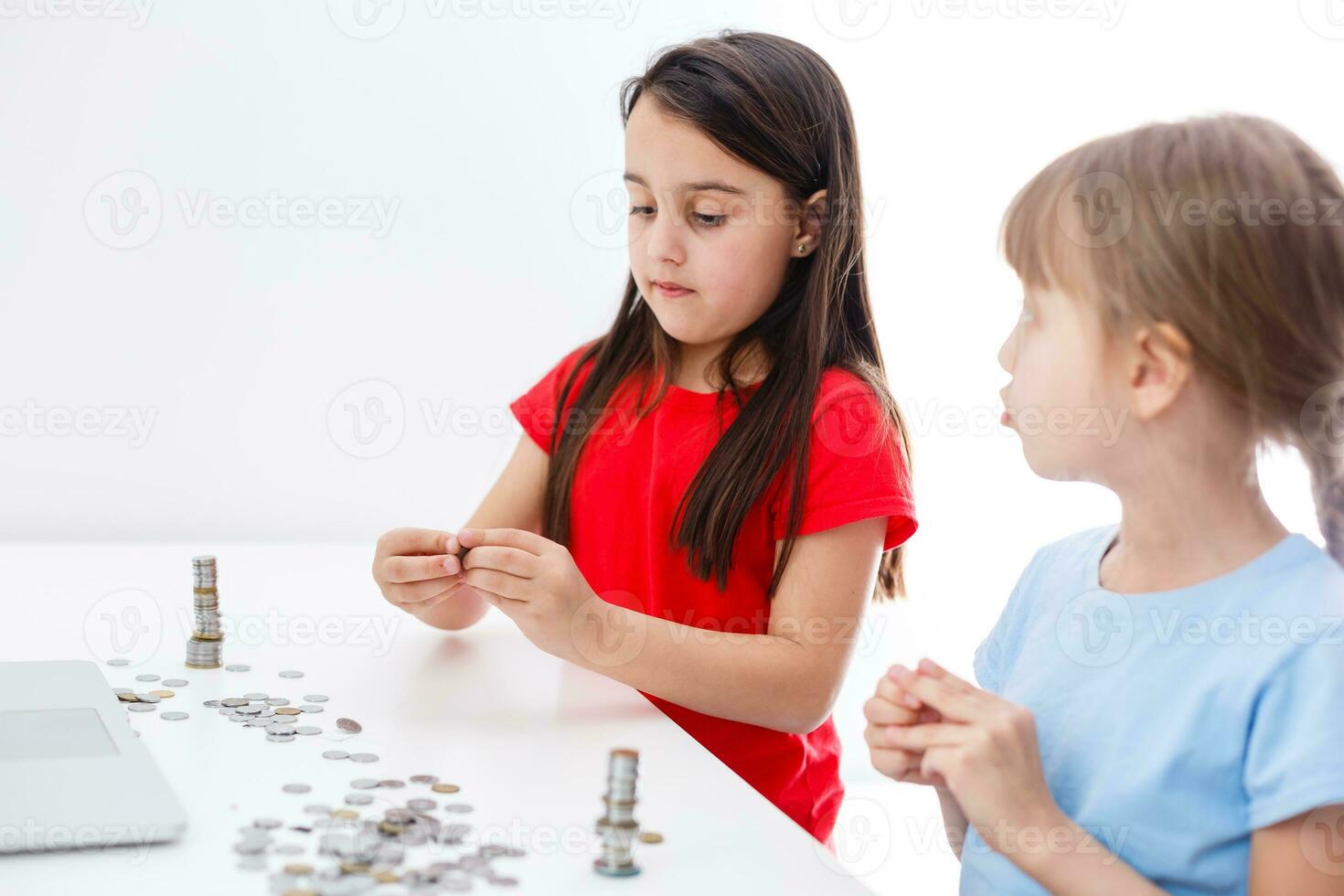 Two kids counting coins together photo