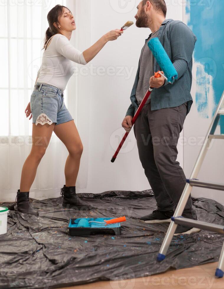Enjoying the renovation by singing and dancing at tools. Apartment redecoration and home construction while renovating and improving. Repair and decorating. photo