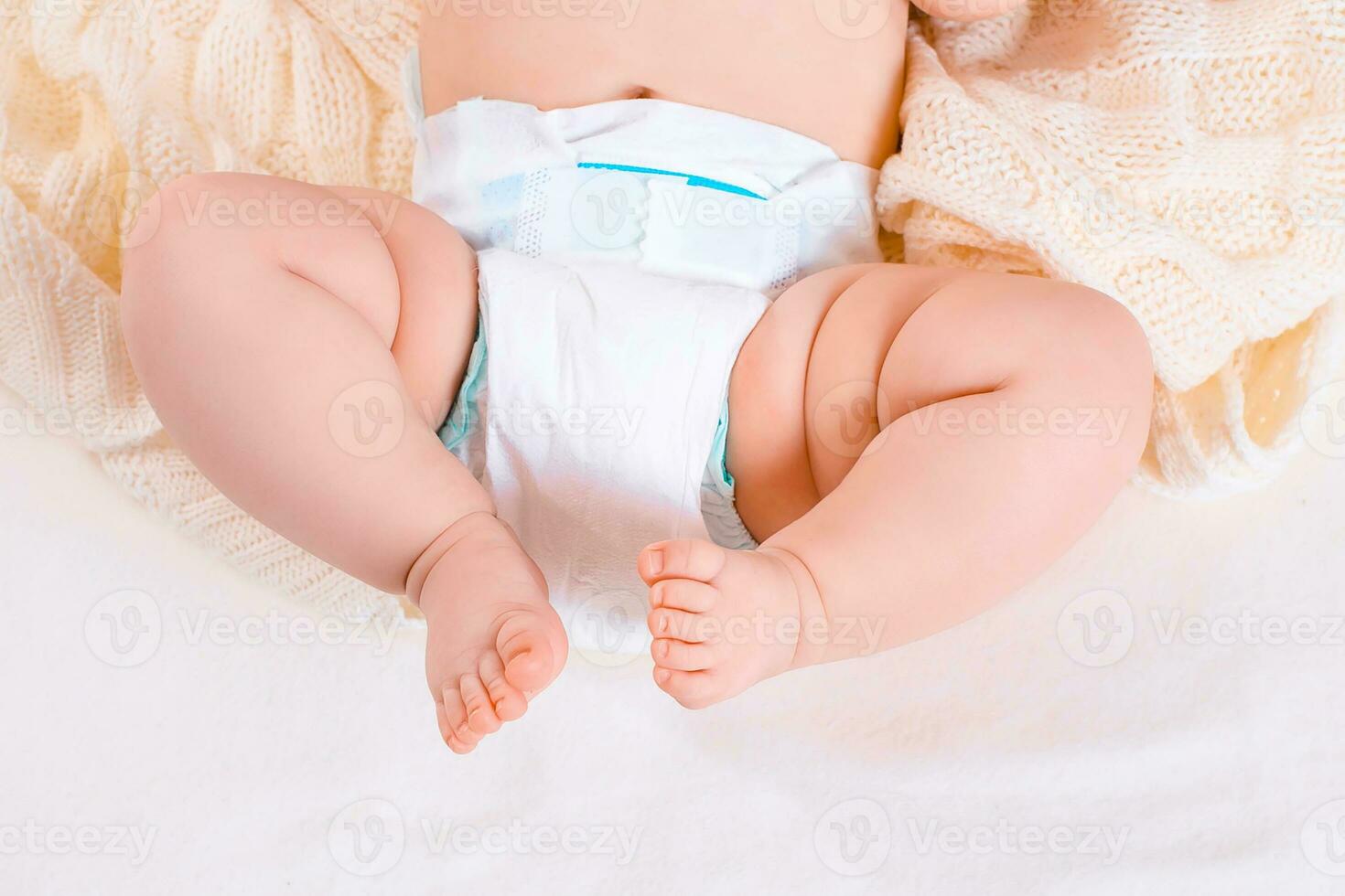 feet of a six months old baby wearing diapers photo