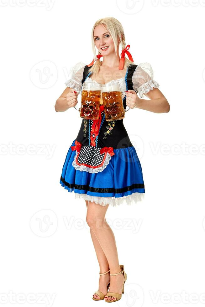 Full length portrait of a blond woman with traditional costume holding beer glasses isolated on white background. photo