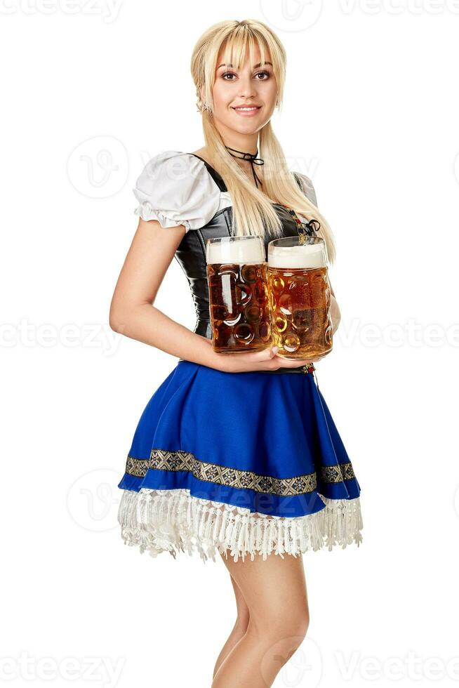 Full length portrait of a blond woman with traditional costume holding beer glasses isolated on white background. photo