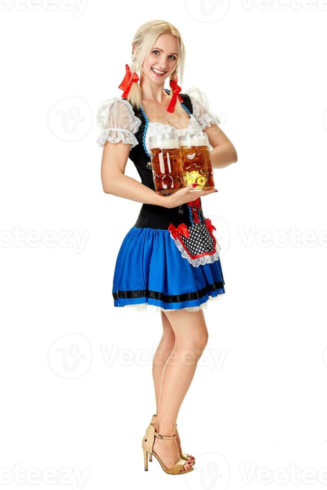 Full length portrait of a blond woman with traditional costume holding beer glasses isolated on white background. photo