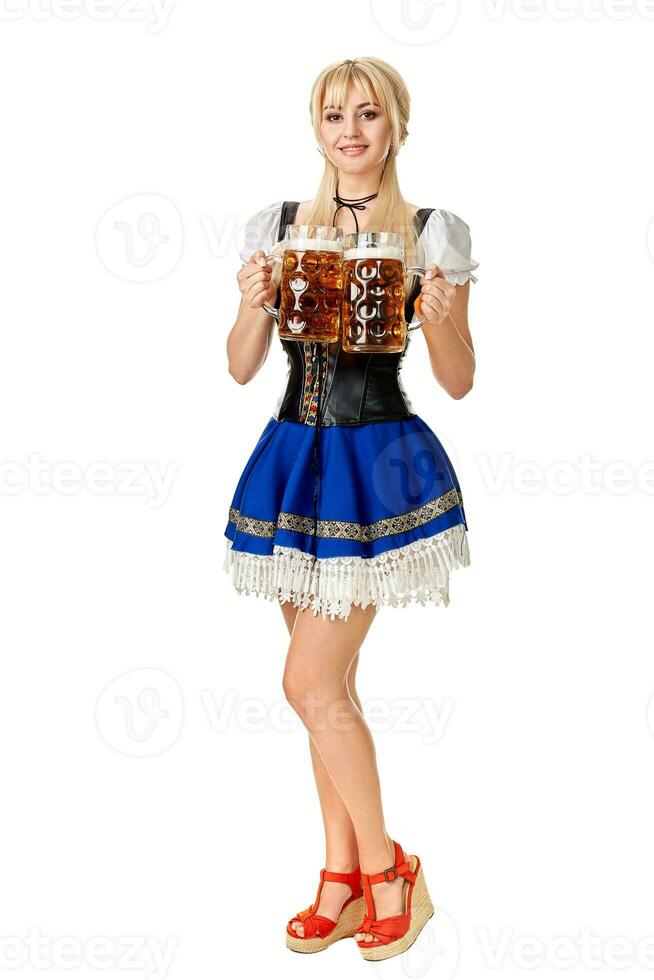 Full length portrait of a blond woman with traditional costume holding beer glasses isolated on white background. photo