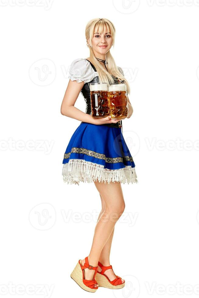 Full length portrait of a blond woman with traditional costume holding beer glasses isolated on white background. photo