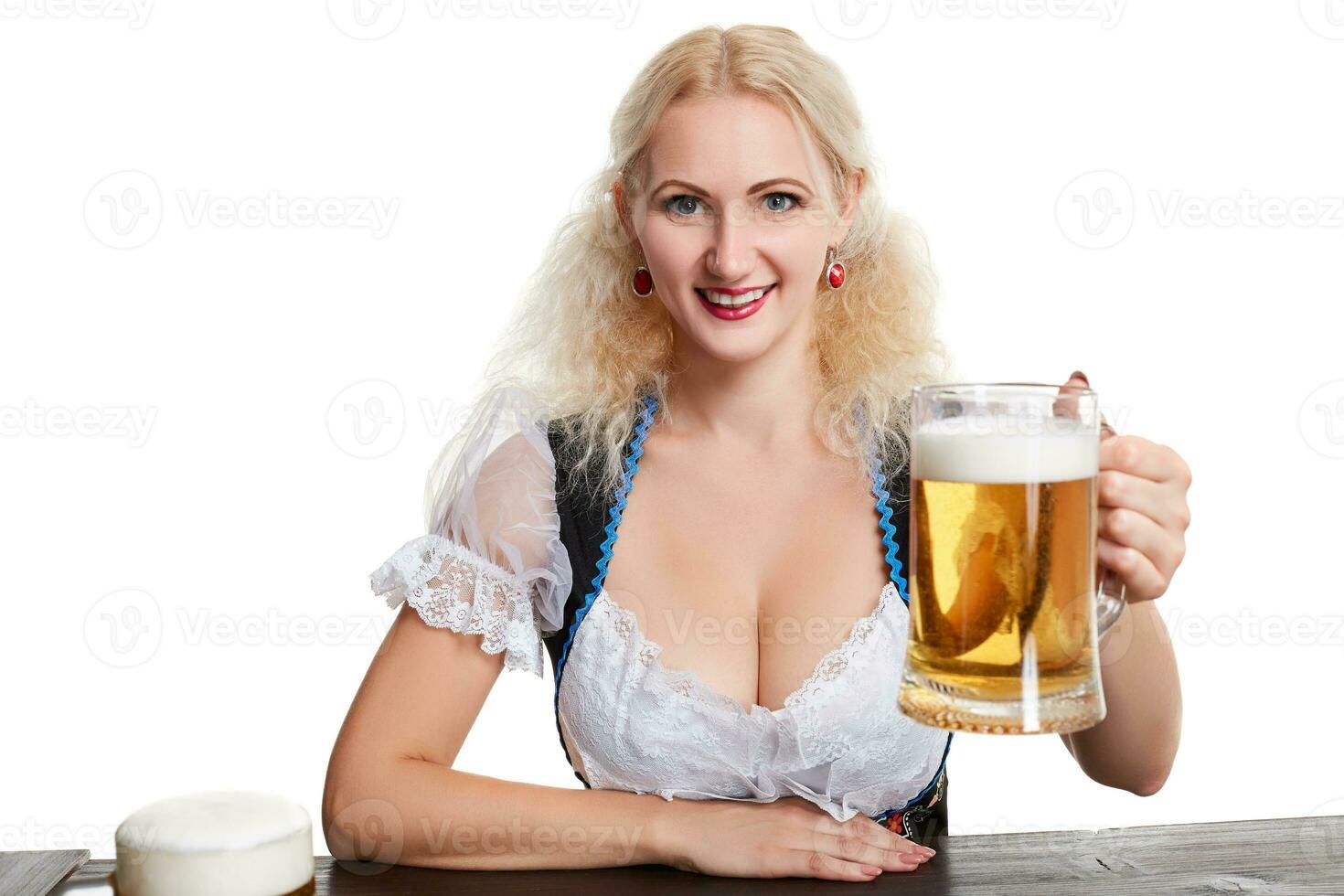 Beautiful young blond girl drinks out of oktoberfest beer stein photo